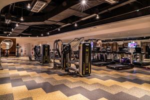 a gym with treadmills and cardio equipment in a room at Oaks Chengdu at Cultural Heritage Park in Chengdu
