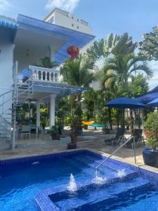 a swimming pool in front of a building at Villa Blue Lagoon in Sihanoukville