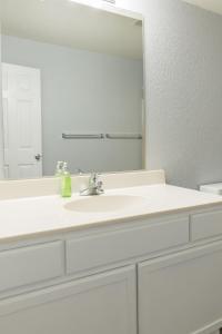 a bathroom with a white sink and a mirror at New King Bed Beautifully Updated KMC1312 in Manhattan