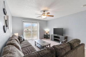 a living room with a couch and a flat screen tv at King Bed, TVs in Every Bedroom, Pet Friendly KMS1409 in Manhattan