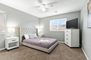 a bedroom with a bed and a flat screen tv at Updated, King Bed, Garage and Free Parking KMN1216 in Manhattan