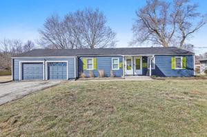 a blue house with yellow doors on a yard at Beautiful Getwaway, Big Back Yard, Huge Side Yard KSQ5616 in Shawnee