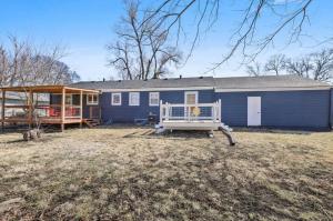 a blue house with a porch in a yard at Beautiful Getwaway, Big Back Yard, Huge Side Yard KSQ5616 in Shawnee