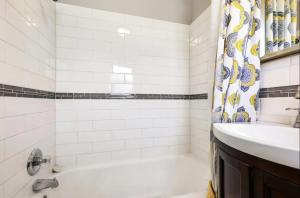 a bathroom with a tub and a sink and a shower at Beautiful Getwaway, Big Back Yard, Great Deck KSQ5614 in Shawnee