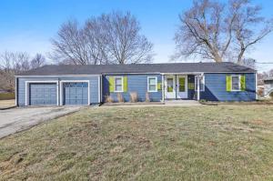 a blue house with yellow doors on a yard at Beautiful Getwaway, Big Back Yard, Great Deck KSQ5614 in Shawnee