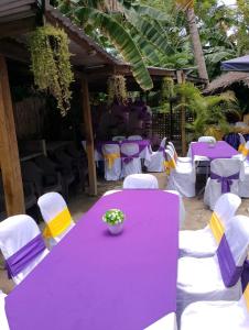 a purple table and chairs with a purple and yellow table at Two crazy monkeys in Bakjawan