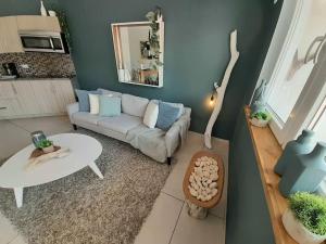 a living room with a couch and a table at Aruba Condo The Pearl - At Eagle Beach - minute walk! in Palm-Eagle Beach