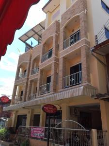 a large building with balconies on the side of it at Baan Taweesuk Guest House in Hua Hin