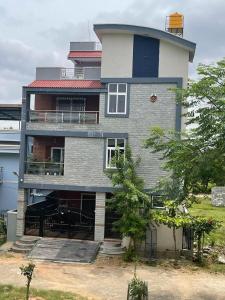 a large house with a balcony on the side of it at Ghar-fully furnished house with 2 Bedroom hall and kitchen in Bangalore