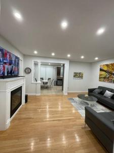 a living room with a couch and a fireplace at Luxury 4-Bedrooms Home… in Brampton