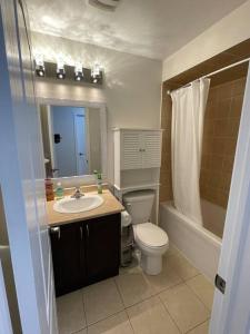 a bathroom with a toilet and a sink and a shower at Luxury 4-Bedrooms Home… in Brampton
