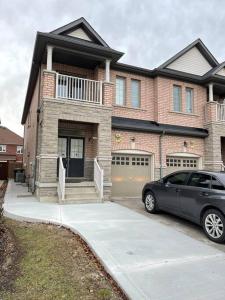 a black car parked in front of a house at Luxury 4-Bedrooms Home… in Brampton