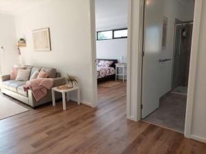 a living room with a couch and a table at Lake and Railway Guesthouse in Drysdale