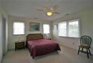 a bedroom with a bed and a ceiling fan at Belvedere in Edisto Island