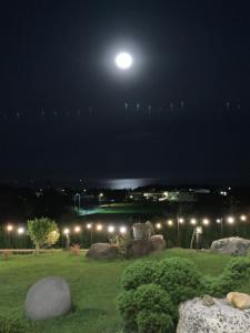 a full moon over a park at night at Happiness House B&B in Chenggong