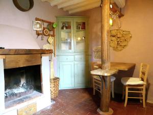 a living room with a fireplace and a green cabinet at Belvilla by OYO Due Cuori in Lucchio