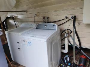 a washer and dryer in a room with a wall at Meyenburg Glamping in Mount Morgan