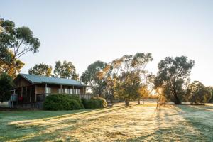 a house on a field with a dirt road in front at Happy Wanderer Holiday Resort The Grampians in Wartook