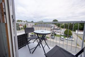 a balcony with a table and a view of a parking lot at Le Contemporain in Rouyn