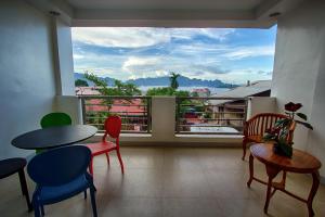 a room with a table and chairs and a large window at Haven 1916 Pension House in Coron