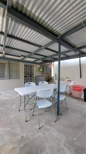 a white table and chairs in a garage at Mead Road Homestay Tours &Transfers Deluxe Flat 1 Bedroom in Suva
