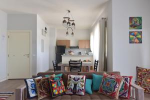 a living room with a couch with colorful pillows at El Gouna Lagoon Paradise Penthouse in Hurghada