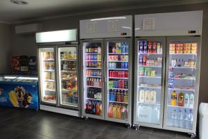 a store with two refrigerators with drinks and drinks at Happy Wanderer Holiday Resort The Grampians in Wartook