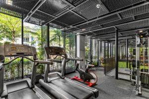 a gym with two treadmills and elliptical machines at BLESSED Hotel in Ho Chi Minh City