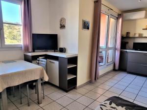 a room with a desk with a computer and a window at Appartement Cerbère, 2 pièces, 4 personnes - FR-1-309-361 in Cerbère