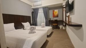 Postel nebo postele na pokoji v ubytování Sienna Residence Bogor