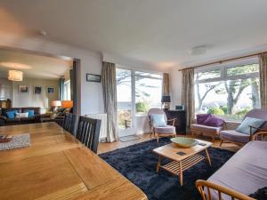 a living room with a table and a dining room at Blue Seas in Saint Mawes