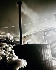a smoke stack with snow on the side of a building at TRENDY HOUSE 193 in Mátranovák