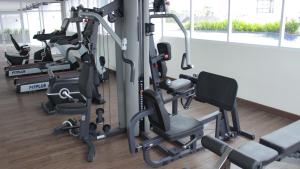 a gym with several tread machines in a room at Sienna Residence Bogor in Kedungbadak