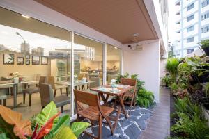 a patio with a table and chairs and a restaurant at Bangkok Loft Inn in Bangkok