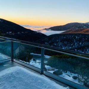 a balcony with a view of a snowy mountain at Woodsmoke Two Falls Creek in Falls Creek
