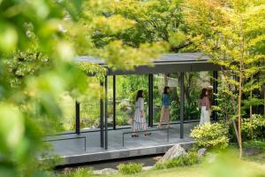 three women standing in a pavilion in a garden at The Hotel Seiryu Kyoto Kiyomizu - a member of the Leading Hotels of the World- in Kyoto