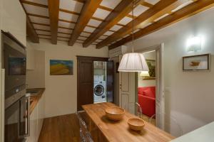 a kitchen with a dining room table and a room with a washing machine at Apartments Florence - Vigna Nuova Alberti in Florence