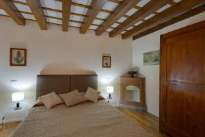 a bedroom with a large bed with a wooden ceiling at Apartments Florence - Vigna Nuova Alberti in Florence