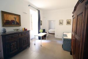 Cette chambre comprend une commode, un lit et une table. dans l'établissement Nido Degli Angeli, à Rome