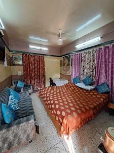 um quarto com uma cama grande e um sofá em Jagan Hotel & Restaurant em Dhaulpur