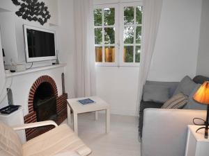 a living room with a couch and a fireplace at Villa Landaise Rénovée Proche Plages - Jardin et Terrasse Privatifs - FR-1-413-80 in Capbreton