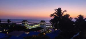 a resort with a view of the beach at night at SHANKAR by the SEA, 2 min from Mandrem Beach in Mandrem