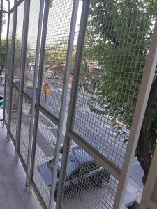 a metal fence with a view of a body of water at DEPARTAMENTOS Alquiler Temporario UNIVERSAL in Godoy Cruz