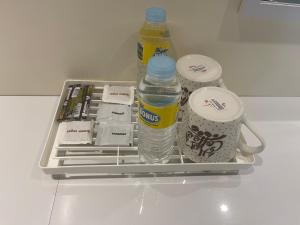 a refrigerator with two bottles of water and other items at Summer room B in Dumaguete