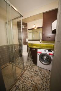a bathroom with a washing machine and a toilet at Cumbali Luxury Boutique Hotel in Istanbul