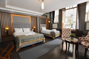 a hotel room with two beds and a living room at Cumbali Luxury Boutique Hotel in Istanbul