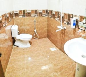 a bathroom with a toilet and a sink at Gulshan Palace Near Millennium Mall Agha khan Hospital Airport Karachi in Karachi