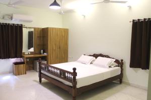 מיטה או מיטות בחדר ב-Indian Residency