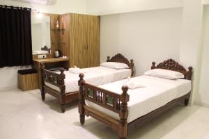 A bed or beds in a room at Indian Residency