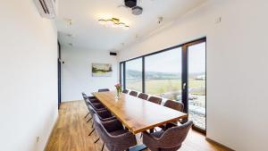 a dining room with a table and chairs and a large window at Point 7 Hotel in Fulda